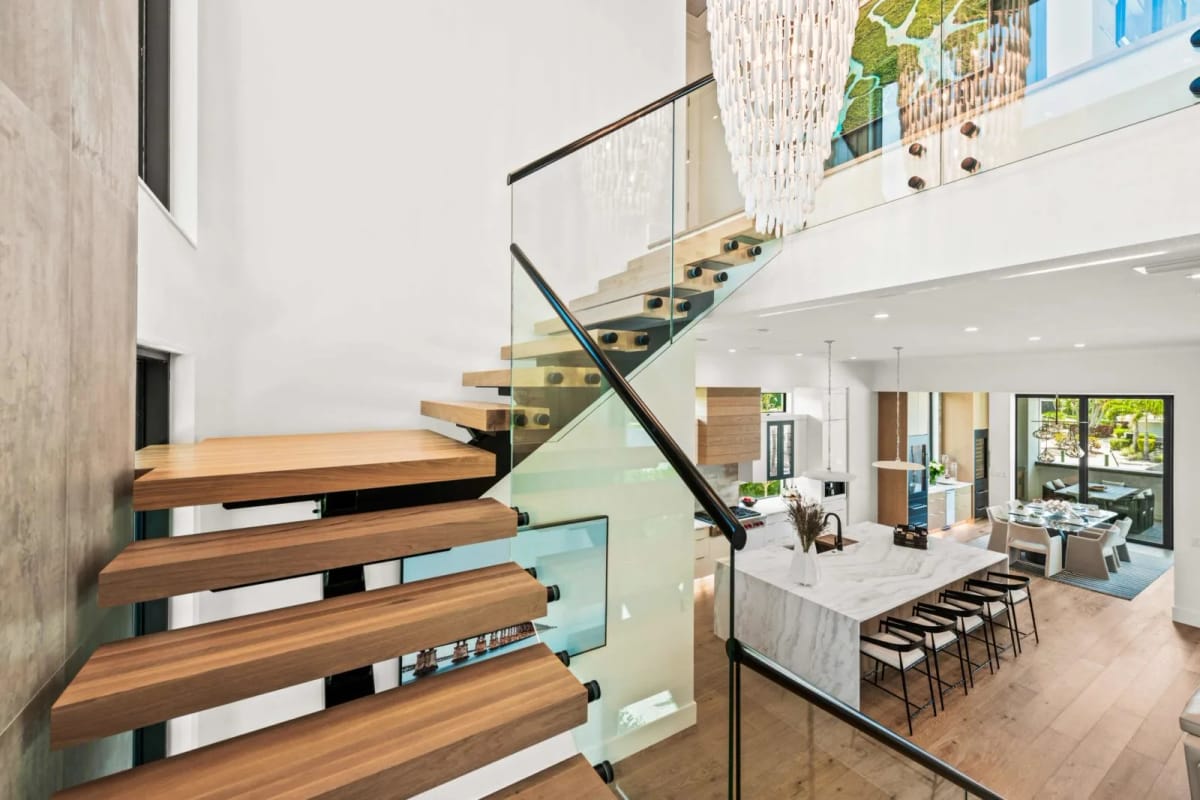 Floating wood staircase with glass railing