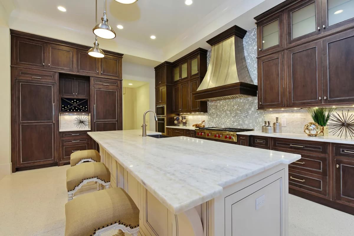 Kitchen with artistic metal range hood