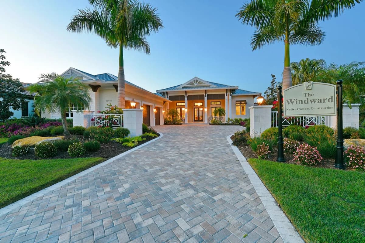 The Windward front exterior with palm-lined drive