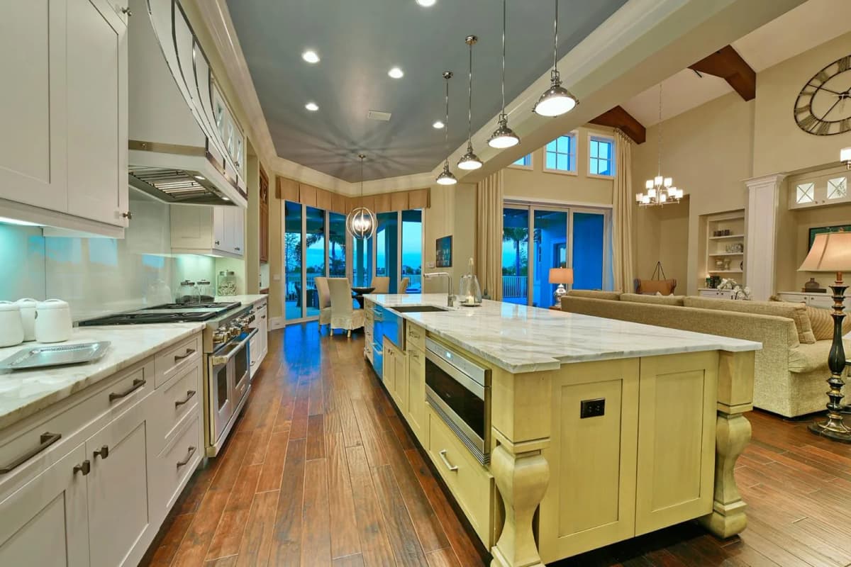 Kitchen with handcrafted range hood under vaulted ceiling